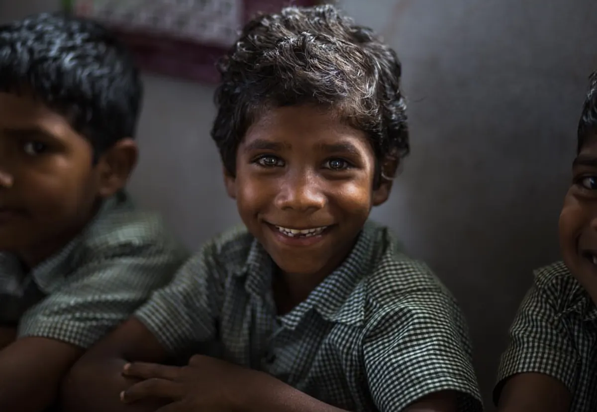 Portrait of a smiling schoolboy in a checked uniform